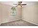 Bedroom featuring a large window for natural light and a ceiling fan for comfortable air circulation at 175 Regency Park Dr, Mcdonough, GA 30253