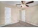 Bedroom with carpet, ceiling fan, two doors, offering a functional and comfortable space at 175 Regency Park Dr, Mcdonough, GA 30253