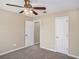 Bedroom with carpet, ceiling fan, and two doors, offering a functional and comfortable space at 175 Regency Park Dr, Mcdonough, GA 30253