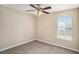 Bedroom featuring a large window for natural light and a ceiling fan for comfortable air circulation at 175 Regency Park Dr, Mcdonough, GA 30253