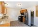 Functional kitchen with stainless steel appliances, granite countertops, wood cabinets, and gray vinyl flooring at 175 Regency Park Dr, Mcdonough, GA 30253