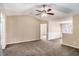 Open-concept living room with neutral walls, carpet flooring and a ceiling fan with lighting at 175 Regency Park Dr, Mcdonough, GA 30253