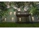Two-story home with a wooden deck and a grassy backyard at dusk at 1945 Grayson Oaks Ct, Lawrenceville, GA 30045