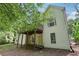 Exterior showcasing a backyard with a two-story deck, lawn and wooded area, perfect for outdoor enjoyment at 1945 Grayson Oaks Ct, Lawrenceville, GA 30045