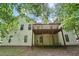 Spacious backyard view featuring a wooden deck and a lawn area, surrounded by trees, ideal for outdoor enjoyment at 1945 Grayson Oaks Ct, Lawrenceville, GA 30045