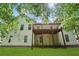 Spacious backyard featuring a wooden deck, lawn, and wooded area, perfect for outdoor activities and relaxation at 1945 Grayson Oaks Ct, Lawrenceville, GA 30045