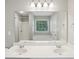 Bright primary bathroom with white cabinets, dual sinks, and large mirror at 1945 Grayson Oaks Ct, Lawrenceville, GA 30045