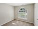 A bright bedroom featuring neutral paint and carpet, and a large arched window for natural light at 1945 Grayson Oaks Ct, Lawrenceville, GA 30045