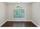 Dining room features dark wood floors, chandelier and large window providing natural light at 1945 Grayson Oaks Ct, Lawrenceville, GA 30045