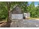 Front exterior highlighting the two car garage and stone facade at 1945 Grayson Oaks Ct, Lawrenceville, GA 30045
