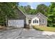 Exterior showcasing a two-car garage and stone detailing at 1945 Grayson Oaks Ct, Lawrenceville, GA 30045