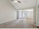 Open living room with vaulted ceiling, neutral carpet, and view into dining area at 1945 Grayson Oaks Ct, Lawrenceville, GA 30045