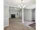 Open-concept living room with fireplace, neutral walls and carpet, and stylish pillars at 1945 Grayson Oaks Ct, Lawrenceville, GA 30045