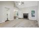 Bright living room with a fireplace, neutral carpet, and view into dining area at 1945 Grayson Oaks Ct, Lawrenceville, GA 30045