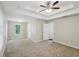Large main bedroom featuring a tray ceiling with fan and connecting door to bath at 1945 Grayson Oaks Ct, Lawrenceville, GA 30045