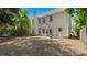 Backyard features a patio area with chairs, mature trees, and a spacious lawn at 248 Colony Center Dr, Woodstock, GA 30188