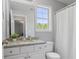 Well-lit bathroom features a window above the granite countertop and a shower-tub combo at 248 Colony Center Dr, Woodstock, GA 30188