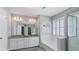 This bathroom includes a soaking tub, double sink vanity, and a glass-enclosed shower at 248 Colony Center Dr, Woodstock, GA 30188