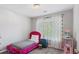 Cozy bedroom with a bright pink velvet bed frame and light streaming through the window at 248 Colony Center Dr, Woodstock, GA 30188