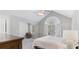 This bedroom is bright with a large window, vaulted ceilings, and neutral carpeting at 248 Colony Center Dr, Woodstock, GA 30188