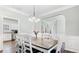 Dining room with hardwood floors, chandelier and adjacent kitchen at 248 Colony Center Dr, Woodstock, GA 30188