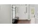 Functional entryway with a coat rack, bench, and wood-look floors at 248 Colony Center Dr, Woodstock, GA 30188