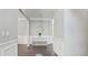 Elegant foyer featuring hardwood floors, white trim, and a decorative mirror at 248 Colony Center Dr, Woodstock, GA 30188