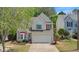 Charming two-story home with landscaped front yard and attached two-car garage at 248 Colony Center Dr, Woodstock, GA 30188