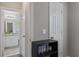Hallway view into the bathroom, boasting white cabinets and granite countertops at 248 Colony Center Dr, Woodstock, GA 30188