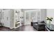 Cozy living room featuring hardwood floors, large window, and built-in bookshelves at 248 Colony Center Dr, Woodstock, GA 30188
