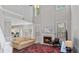 Bright living room boasts soaring ceilings, fireplace, large windows, and elegant staircase overlooking the space at 248 Colony Center Dr, Woodstock, GA 30188