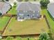 Back exterior featuring a large, grassy yard, patio with a lounge set, and a grill at 3687 Thackary Dr, Powder Springs, GA 30127