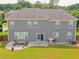 Back exterior featuring a flat, grassy yard, patio with a lounge set, and a grill at 3687 Thackary Dr, Powder Springs, GA 30127