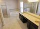 Luxurious bathroom showcasing dual vanities, a separate shower, and a soaking tub for ultimate relaxation at 3687 Thackary Dr, Powder Springs, GA 30127