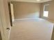 Spacious bedroom with neutral carpeting, ample natural light, and a serene atmosphere for relaxation at 3687 Thackary Dr, Powder Springs, GA 30127