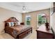 Comfortable bedroom with a ceiling fan, bedside table, and brown comforter with white flowers at 3687 Thackary Dr, Powder Springs, GA 30127