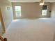 Open and airy bonus room with carpet, a ceiling fan, neutral walls, and bright windows at 3687 Thackary Dr, Powder Springs, GA 30127