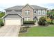Charming two-story home featuring a mix of siding and brick with well-maintained landscaping and a two-car garage at 3687 Thackary Dr, Powder Springs, GA 30127
