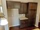 Elegant kitchen boasts dark wood cabinetry, granite countertops, and stylish pendant lighting, offering a modern feel at 3687 Thackary Dr, Powder Springs, GA 30127