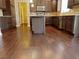 Modern kitchen featuring dark wood cabinets, a center island, stainless steel appliances, and hardwood flooring at 3687 Thackary Dr, Powder Springs, GA 30127