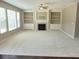 Spacious living room featuring a fireplace with custom built-in shelving and large windows for ample lighting at 3687 Thackary Dr, Powder Springs, GA 30127