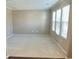 Bright living room with neutral carpet, fresh paint, and ample natural light from multiple windows at 3687 Thackary Dr, Powder Springs, GA 30127