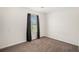 Cozy bedroom featuring plush carpeting, neutral walls, window and dark curtains at 5794 Parks Rd, Cumming, GA 30041