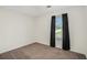 Cozy bedroom with neutral walls, plush carpeting, natural light, and dark curtains at 5794 Parks Rd, Cumming, GA 30041