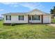 Charming single-story home with a well-maintained lawn, brick accents, and a cozy front porch at 5794 Parks Rd, Cumming, GA 30041