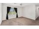 Inviting living room featuring neutral walls, plush carpeting, natural light, and dark curtains at 5794 Parks Rd, Cumming, GA 30041