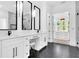 Bright bathroom featuring double sinks, marble accents, and modern fixtures with a glimpse into the walk-in closet at 801 Braselton Hwy, Lawrenceville, GA 30043