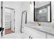 Bathroom featuring a shower, white vanity with a countertop and a glimpse of the walk-in closet at 801 Braselton Hwy, Lawrenceville, GA 30043