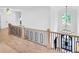 Bright foyer with modern railings, hardwood floors, and chandelier lighting, creating a grand and inviting entrance at 801 Braselton Hwy, Lawrenceville, GA 30043