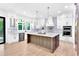 New kitchen boasts a large island, stainless steel appliances, and modern lighting fixtures at 801 Braselton Hwy, Lawrenceville, GA 30043